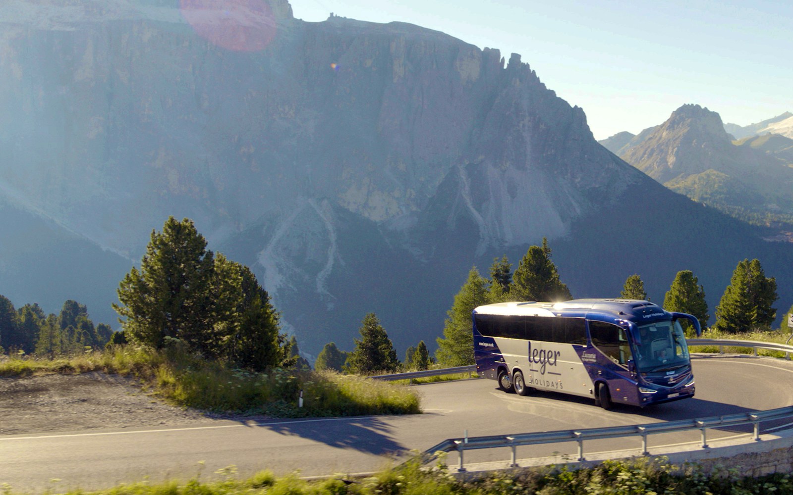 A Leger Holidays Luxuria coach travelling through the Italian Dolomites