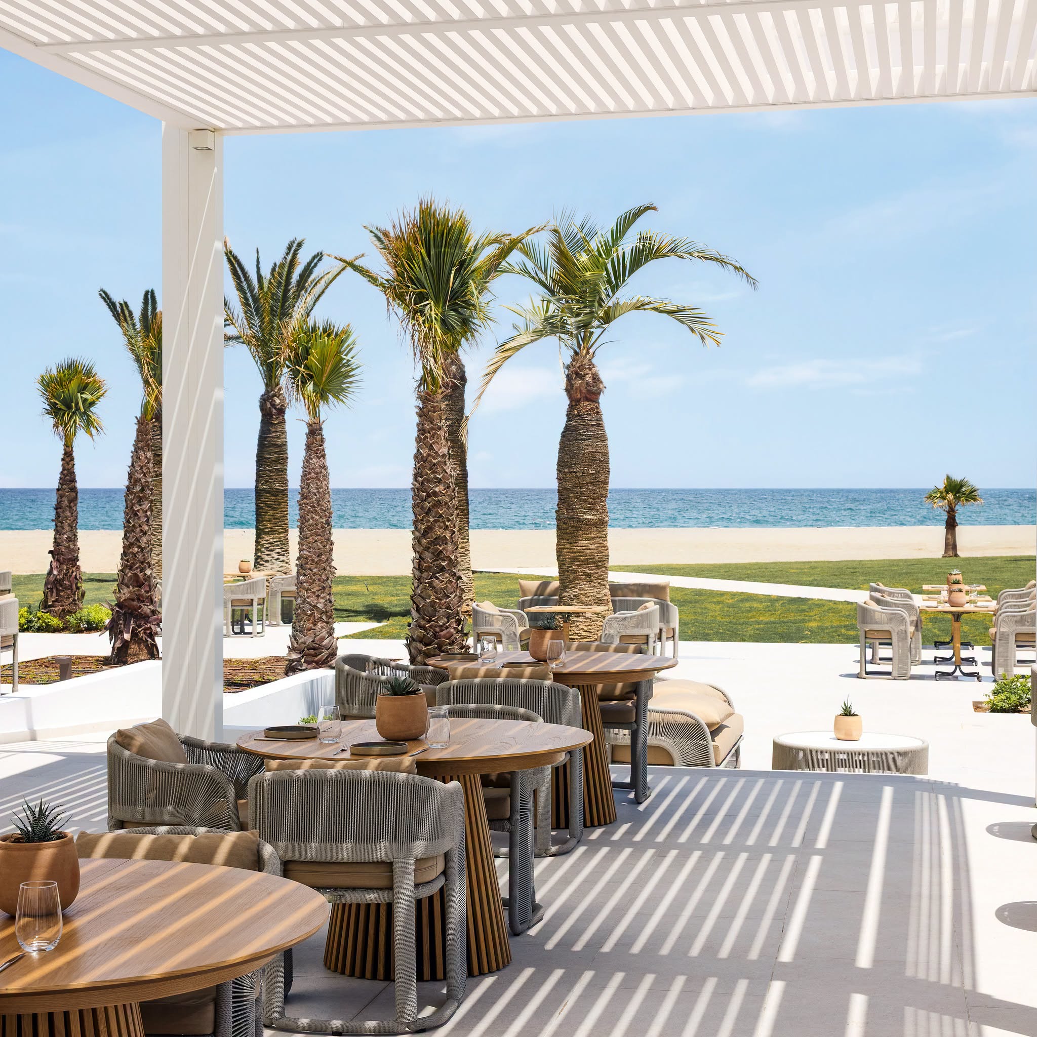 Beachfront terrace and Aegean Sea at Creta Palace in Crete