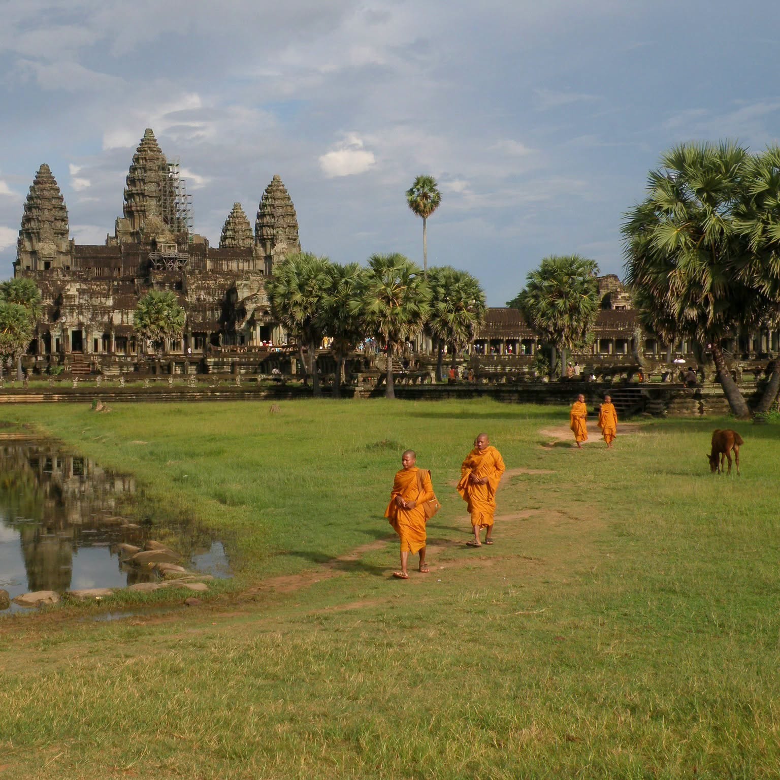 Buddhist monks walking past Angkor Wat